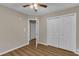 This bedroom with wood floors and closet boasts convenience with access to other rooms at 134 Riverwalk Cir, Cary, NC 27511