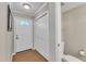 Entryway featuring a door with decorative glass, closet, and half-bath at 134 Riverwalk Cir, Cary, NC 27511