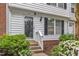 Inviting front entrance with decorative door, blooming flowers, and manicured shrubs at 134 Riverwalk Cir, Cary, NC 27511