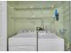 Functional laundry room with washer, dryer, shelving, and ample storage space for supplies at 134 Riverwalk Cir, Cary, NC 27511