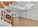 Open living room and staircase with fireplace and sliding glass doors to backyard at 134 Riverwalk Cir, Cary, NC 27511