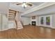 Cozy living room with a fireplace, hardwood floors, and a walkout to the yard through French doors at 134 Riverwalk Cir, Cary, NC 27511