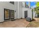 This home features a concrete patio with a pair of glass doors providing natural lighting and air conditioning unit at 134 Riverwalk Cir, Cary, NC 27511