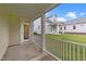 Inviting covered back porch with white railing overlooks the lawn and community at 143 Swain St, Clayton, NC 27527