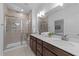 Bathroom featuring dual vanities, a spacious shower, and modern fixtures at 143 Swain St, Clayton, NC 27527