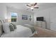 Bright bedroom with white furniture, neutral carpet, and natural light from two large windows at 143 Swain St, Clayton, NC 27527
