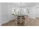 Bright dining area with modern lighting, four chairs and wood-look flooring at 143 Swain St, Clayton, NC 27527