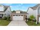 Charming home exterior with two-car garage, brick accents, and professionally landscaped yard at 143 Swain St, Clayton, NC 27527