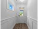 Bright foyer with white trim, wood-look flooring, and a view of the neighborhood at 143 Swain St, Clayton, NC 27527