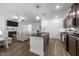Open-concept kitchen with an island, stainless appliances, and hardwood floors at 143 Swain St, Clayton, NC 27527