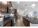 Modern kitchen with granite countertops, stainless appliances, and dark wood cabinets at 143 Swain St, Clayton, NC 27527