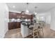 Modern kitchen with dark wood cabinets, granite countertops, and a central island with seating at 143 Swain St, Clayton, NC 27527