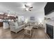 Inviting living room featuring wood floors, a fireplace, and an open layout connecting to the kitchen at 143 Swain St, Clayton, NC 27527