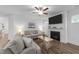 Inviting living room featuring a fireplace, TV, wood floors, and comfortable seating at 143 Swain St, Clayton, NC 27527