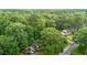 Secluded home surrounded by lush trees, featuring a large lawn and driveway at 1503 Laughridge Dr, Cary, NC 27511