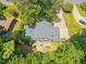 Aerial perspective of the home, showcasing its roof, deck, and the surrounding trees and landscape at 1503 Laughridge Dr, Cary, NC 27511