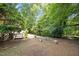 Lush backyard with a serene pathway and seating, perfect for relaxation and enjoying nature at 1503 Laughridge Dr, Cary, NC 27511