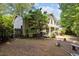Backyard view featuring a patio area, lush trees, and landscaping providing a private outdoor space at 1503 Laughridge Dr, Cary, NC 27511