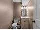 Cozy powder room with a stylish vanity, a decorative mirror, and a well-maintained toilet at 1503 Laughridge Dr, Cary, NC 27511