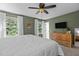 Relaxing bedroom featuring a king size bed, wood trim, and soothing sage green walls at 1503 Laughridge Dr, Cary, NC 27511