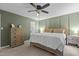 Relaxing bedroom featuring a king size bed, wood trim, and soothing sage green walls at 1503 Laughridge Dr, Cary, NC 27511