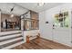 Inviting entryway with a bench seat, staircase, and natural light from the front door at 1503 Laughridge Dr, Cary, NC 27511