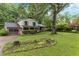 Charming two-story home with a well-manicured lawn, mature trees, and attached garage at 1503 Laughridge Dr, Cary, NC 27511
