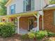 Inviting front porch featuring a porch swing and charming details like hanging flower baskets at 1503 Laughridge Dr, Cary, NC 27511