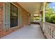 Covered front porch with comfortable seating area, perfect for relaxing and enjoying the neighborhood views at 1503 Laughridge Dr, Cary, NC 27511