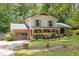 Charming two-story home with brick accents, lush landscaping, and an inviting front porch swing at 1503 Laughridge Dr, Cary, NC 27511