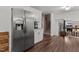 Stainless steel refrigerator integrated into a well-appointed kitchen, leading to an adjacent room through stairs at 1503 Laughridge Dr, Cary, NC 27511