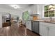 Kitchen with stainless steel appliances and view to the living room, and dining area filled with natural light at 1503 Laughridge Dr, Cary, NC 27511