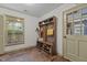 Functional mudroom with bench, shoe storage, hooks for coats, a wooden floor and a window to the yard at 1503 Laughridge Dr, Cary, NC 27511