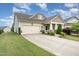 Well-maintained single-Gathering home with a two-car garage and beautifully landscaped front yard at 1528 Anthology Dr, Durham, NC 27703