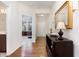 Entryway featuring hardwood floors, elegant lighting, and a view into the living room at 1528 Anthology Dr, Durham, NC 27703