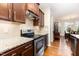 Updated kitchen featuring stainless steel appliances and granite countertops, adjacent to dining area at 1528 Anthology Dr, Durham, NC 27703