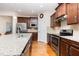 Modern kitchen with granite countertops, stainless steel appliances, and wood flooring at 1528 Anthology Dr, Durham, NC 27703