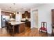 Spacious kitchen with an island and seating, stainless steel appliances, and dark wood cabinets at 1528 Anthology Dr, Durham, NC 27703