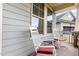 Inviting porch with white rocking chairs and red cushions, perfect for relaxing outdoors at 1528 Anthology Dr, Durham, NC 27703