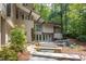 Exterior view of home with patio, stone stairway, hot tub and mature trees at 1604 Pinecrest Rd, Durham, NC 27705
