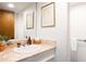 Neutral bathroom with a marble-top sink and vanity at 1604 Pinecrest Rd, Durham, NC 27705