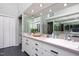 Contemporary bathroom featuring ample counter space, storage, and a large mirror at 1604 Pinecrest Rd, Durham, NC 27705