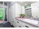Bathroom with modern fixtures, generous counter space, storage, and a glass enclosed shower at 1604 Pinecrest Rd, Durham, NC 27705