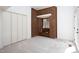 Bright room featuring light carpet, closet doors, and unique brick feature at 1604 Pinecrest Rd, Durham, NC 27705