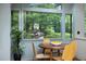 Charming breakfast nook offers a lovely view of a lush, landscaped garden and path at 1604 Pinecrest Rd, Durham, NC 27705