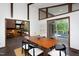Bright dining room featuring a modern table, an outdoor view, and an open floor plan at 1604 Pinecrest Rd, Durham, NC 27705