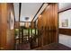 Entryway featuring wood paneling and stained brick flooring at 1604 Pinecrest Rd, Durham, NC 27705