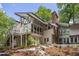 Exterior view of the home with patio, hot tub and large windows at 1604 Pinecrest Rd, Durham, NC 27705