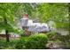 Exterior view of a brick and glass two-story home with mature landscaping at 1604 Pinecrest Rd, Durham, NC 27705