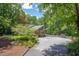 Beautiful home featuring an attached garage, mature trees, and large driveway at 1604 Pinecrest Rd, Durham, NC 27705